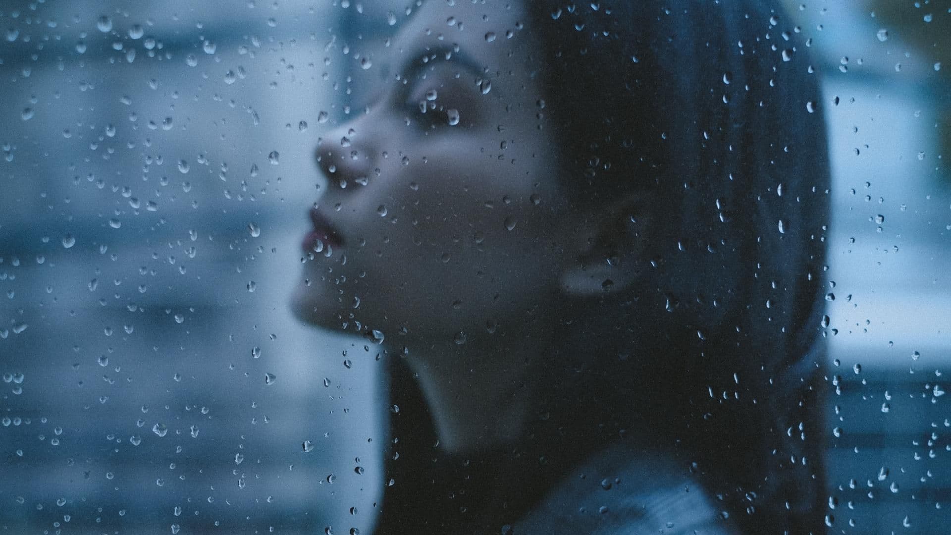 Horoskop Thema: Frau schaut im Regen geradeaus
