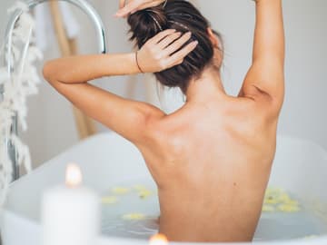 Junge Frau in Badewanne Kerzenschein